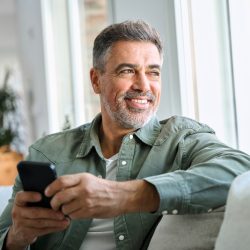 Happy,Older,Mature,Middle,Aged,Man,Holding,Cell,Mobile,Phone