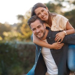 Man,,Woman,And,Portrait,With,Piggyback,In,Park,For,Relationship